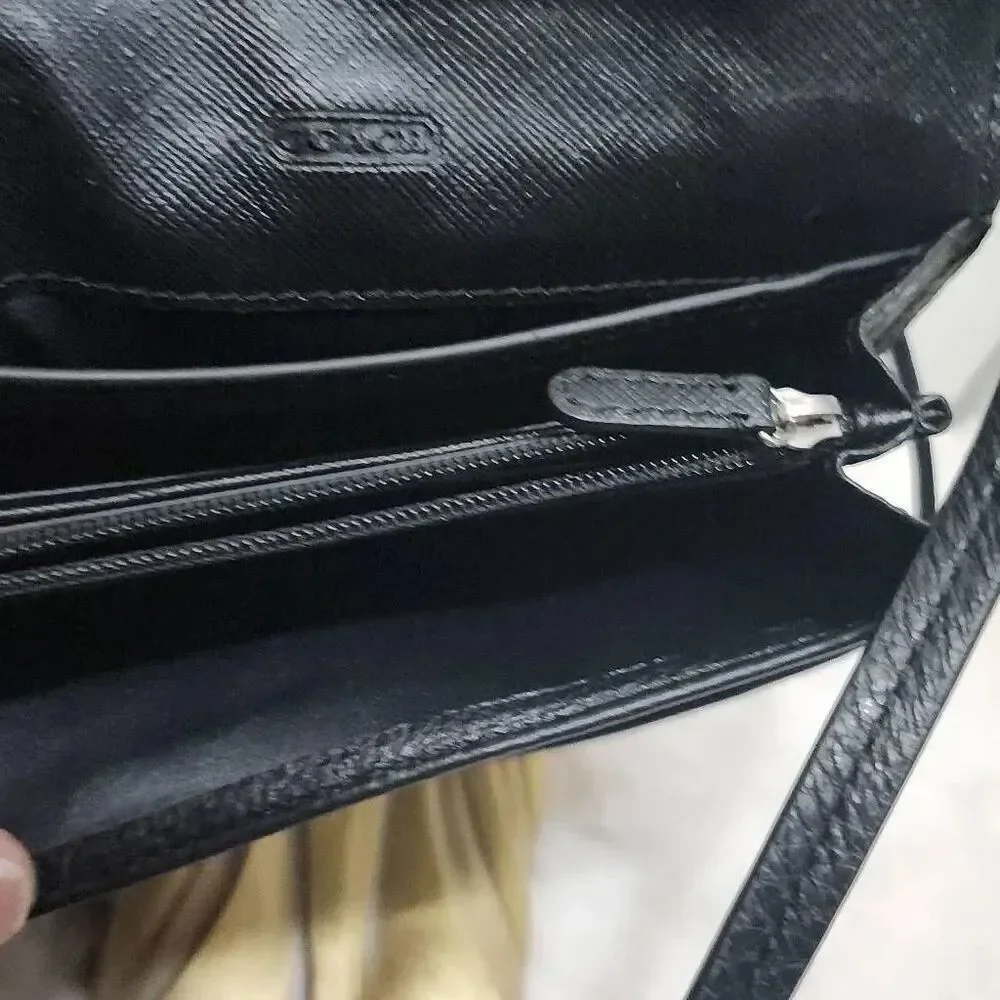 Coach Avery leather phone crossbody w/ a flap closure.